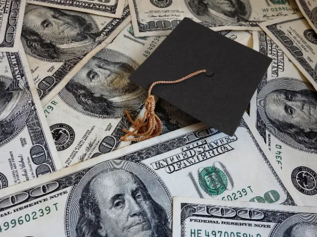graduation cap with money